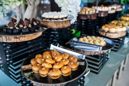 A delicious dessert buffet with various sweet bakery in a restaurant or hotel.