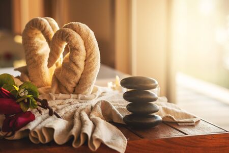 Spa concept with zen stones and towel against sunlight.の写真素材