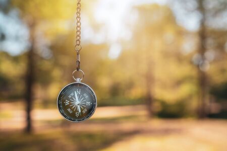finding our way in nature with a compass, looking for the right direction.の写真素材