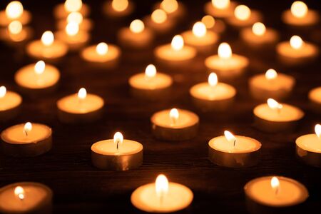Vintage, tea light candles on wooden floor, for celebrating.