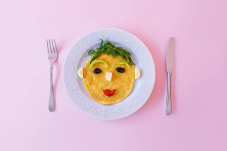 Funny prepared omelette with human face shape for kids.の写真素材