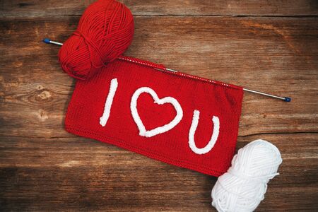 Writing I Love You on knitting with needlework. Valentines day concept