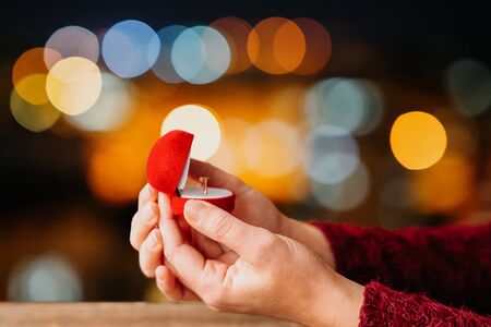 Woman open her gift box jewellery with bokeh led lights background. Valentines day and romance conceptの写真素材