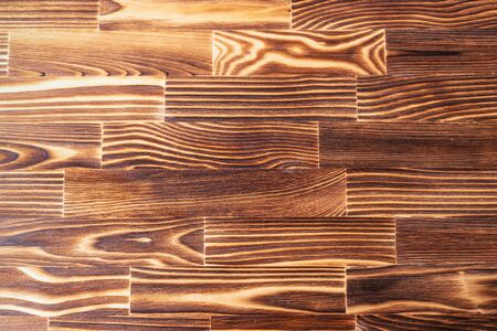 Brown burned and unpainted natural wood with grains for background and textureの写真素材