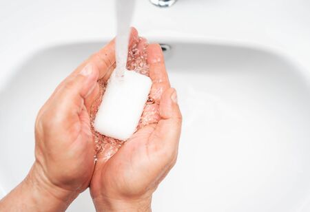 Personal hygiene, cleaning hands with soap often on faucet to protect from virusの写真素材