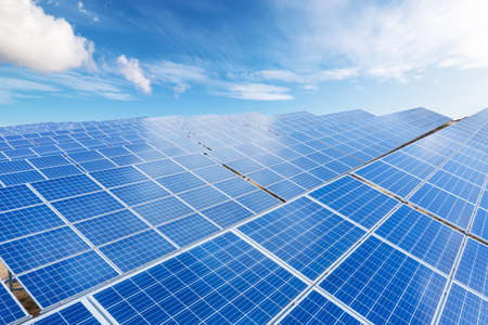 Close up top view of Solar energy panels with blue sky with couds background. Clean and renewable...