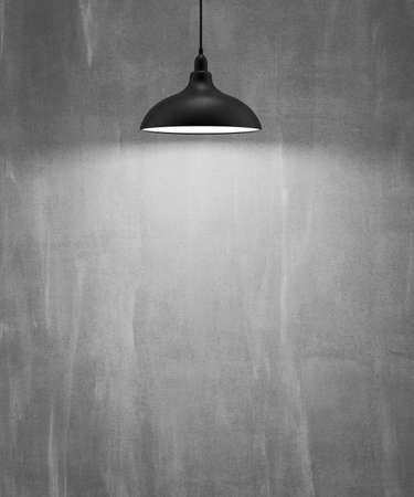 Grungy faded and stained stucco wall with a decoration of modern chandelier concrete and cement pattern with luxury illumination, Textured Backgroundの写真素材