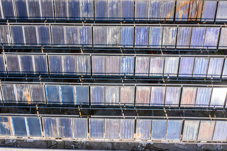 Aerial top view of old and dirty Solar energy panels. Clean and renewable energy concept for a...