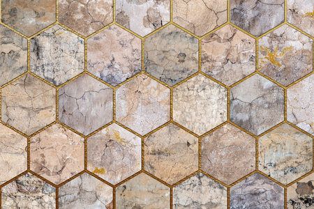 Old, faded and cracked wall collage with golden frames. Concrete, cement and golden wall pattern. Symmetric and hexagon abstract textured Background.の写真素材