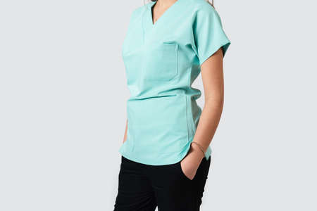 Portrait of a female doctor or nurse wearing turquoise medical uniform. High quality photoの写真素材