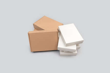 White and brown colored group of cardboard boxes isolated on white background. E-commerce and...