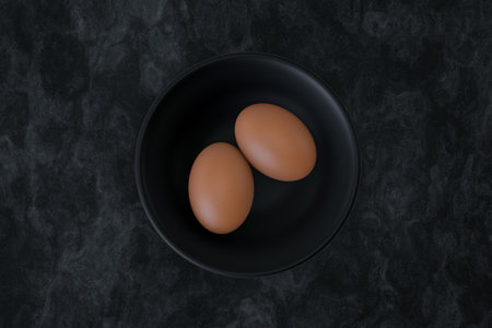 Organic brown raw eggs on black bowl. 3d illustrationの写真素材