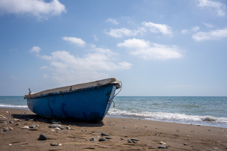 Blue fishing boat on the beach with blue sky. High quality photoの写真素材