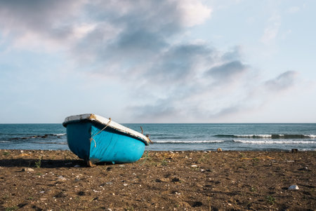 Blue fishing boat on the beach with blue sky. High quality photoの写真素材