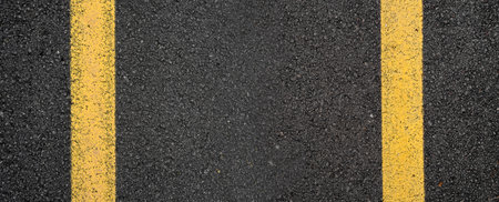 Close-up asphalt road texture with yellow line. High quality photo