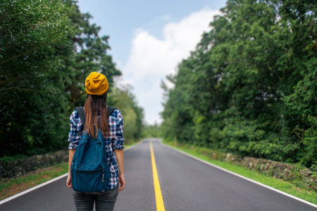 A woman in a yellow beret is travelling with a backpack. High quality photoの写真素材