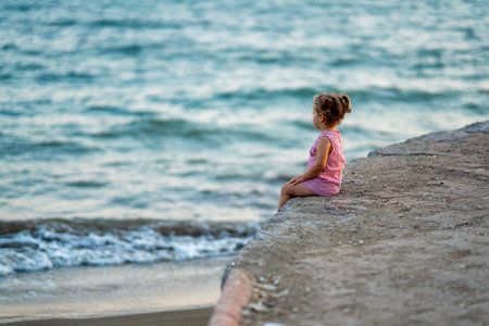 lonely girl watching the sea on the beach. High quality photoの写真素材