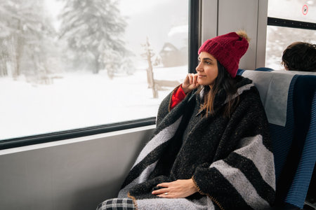 Young woman traveling by train and looking out the window . High quality photoの写真素材