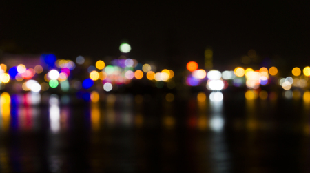 Blur black night background illustration with small colorful shining city lights like dotsの写真素材