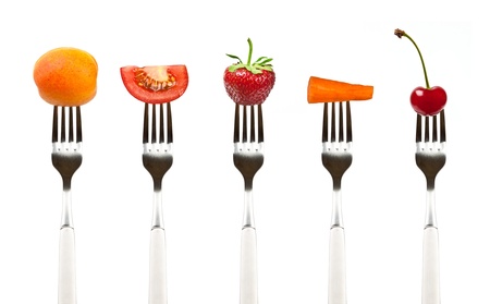 Red fruits and vegetables on the collection of forks, diet healthy eating conceptの写真素材
