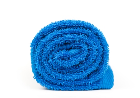 rolled up blue towel isolated on whiteの写真素材