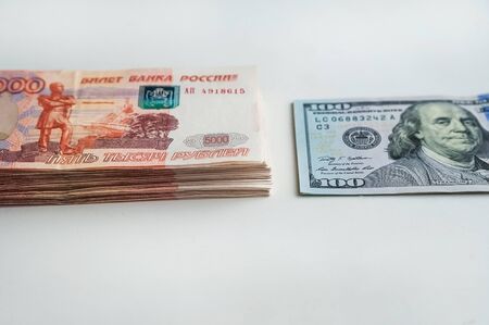 Russian rubles and American dollars. Money on a white background. Money on the texture of a tree. Money, crisis, salary, sale, purchaseの写真素材