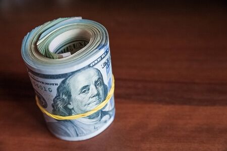 Russian rubles and American dollars. Money on a white background. Money on the texture of a tree. Money, crisis, salary, sale, purchaseの写真素材