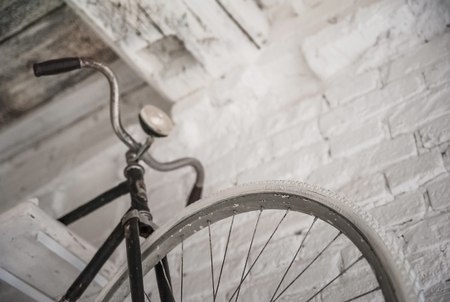 Old white bicycle whist on a white stone wall. Details of the old bicycle.の写真素材