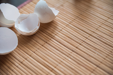 Eggshell on a wooden texture backgroundの写真素材