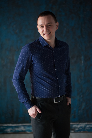 Portrait of a man in a blue shirt on a blue background. Portrait of a man who pondered, pendingの写真素材