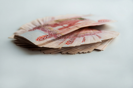 Money. Russian rubles isolated on white background and on a wooden background. Bundles of money