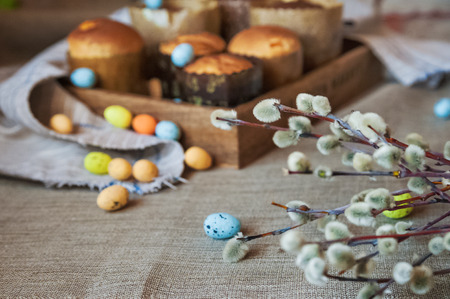 Spring Easter photo. Sprigs of pussy willows, pasques, cakes, colorful eggs. Background and space...