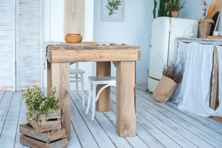 White textured kitchen in the style of shabby. A large textured table in the ecological style and...