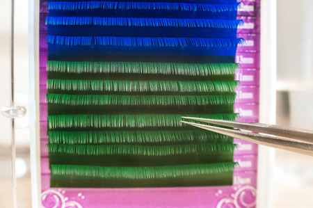 The concept of caring for the eyes, eyelashes, and eyelash extensions in the salon. Eyelash tweezers...