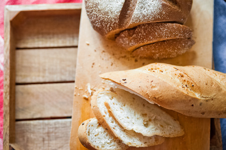 Sliced baguette and round rye black bread. Sandwich with bread, butter and dill. White loaf and rye...