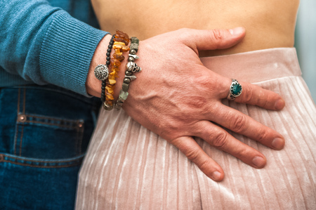 Male hand on a female waistの写真素材