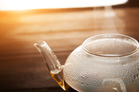 Chinese flower tea teapot with condensation and steam. Concept of tea ceremony with teapot disclosure and copy space.の写真素材