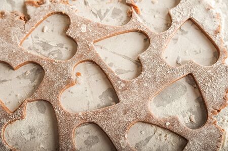 The texture of the dough closeup. Heart shaped gingerbread baking. Homemade cookies for Valentines Day and copy space. Keto baking.の写真素材