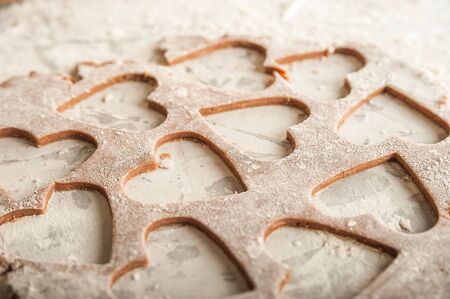 The texture of the dough closeup. Heart shaped gingerbread baking. Homemade cookies for Valentines Day and copy space. Keto baking.の写真素材