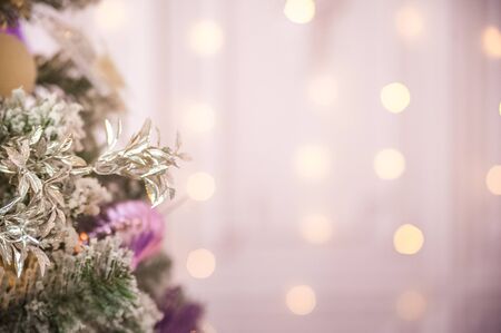 Background from a Christmas tree decorated in blue and purple close-up. Greeting card from a Christmas tree with purple decorations and copy space.の写真素材