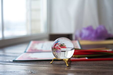 Mysticism in everyday life. Esoteric in a magic ball close-up and copy space. Fortune telling on the ball.の写真素材