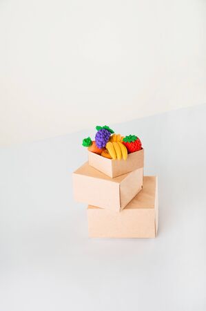 Delivery concept on a white background. Delivery of goods, food online. A lot of boxes with food on a white background close-up.の写真素材