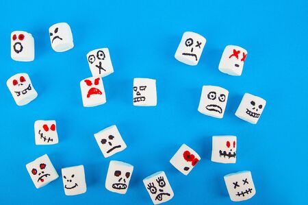 Marshmallows close-up and copy space on blue background. Marshmallows for Halloween emoticons.の写真素材