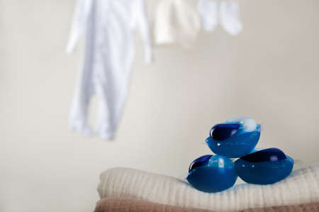 Laundry capsules close-up and copy space. Laundry, clothes drying on a rope, laundry basket, washing powder, washing gel.の写真素材