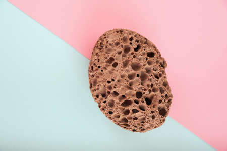 Pumice stone close up and copy space. Pumice stone 3d on a pink background. Beauty concept. Background for cosmetic product branding, identity and packaging inspiration. Podium with pink carnations anの写真素材