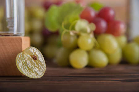 Cold pressed grape oil. Organic bio care products with natural ingredients. Close-up grapes and copy space. Halved grapes and grape seeds.の写真素材