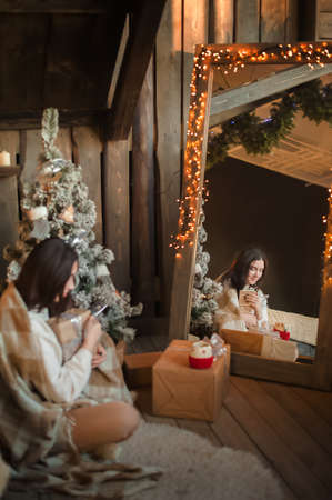 Woman at home for New Years or Christmas in the bedroom.の写真素材