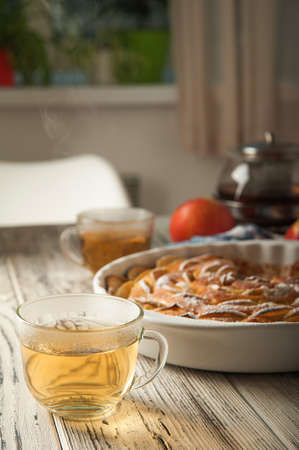 Heap of homemade apple pie close-up and copy space. A quick autumn dessert idea with tea. Autumn pie with apples, Rustic wooden background.の写真素材