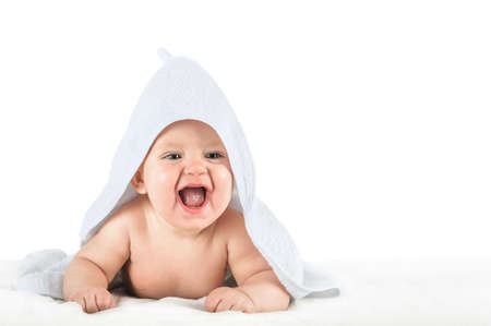 Close-up child in white towel isolated on white background. Bathing babies and restful sleep. funny toddler.の写真素材