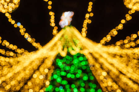 Christmas background gold lights in defocus. Yellow lights on black background place for textの写真素材